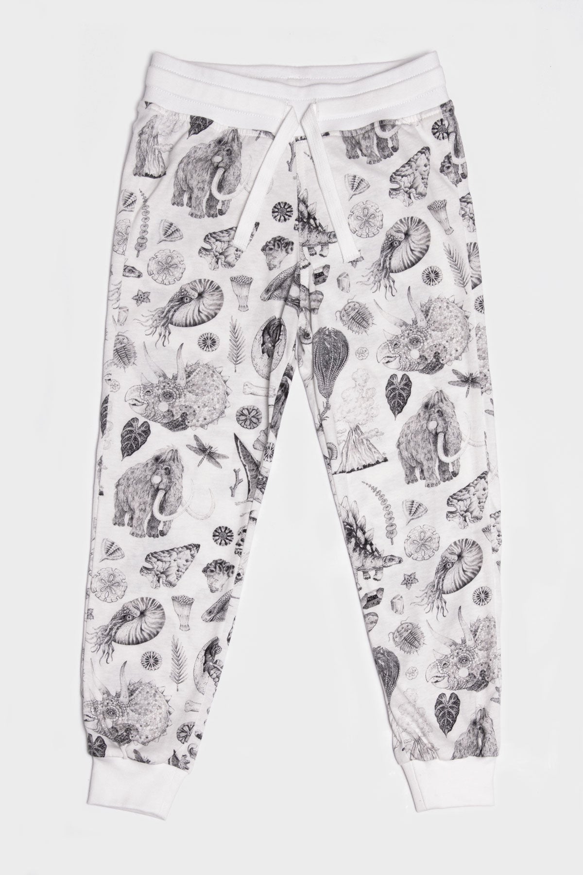The lightweight jersey track pants made out of 100% cotton offer big comfort without compromising on cool. With our famous prehistoric print by Tattoo-Artist Suflanda the elasticated waist and the adjustable string detail will make sure you’re the coolest kid in town.