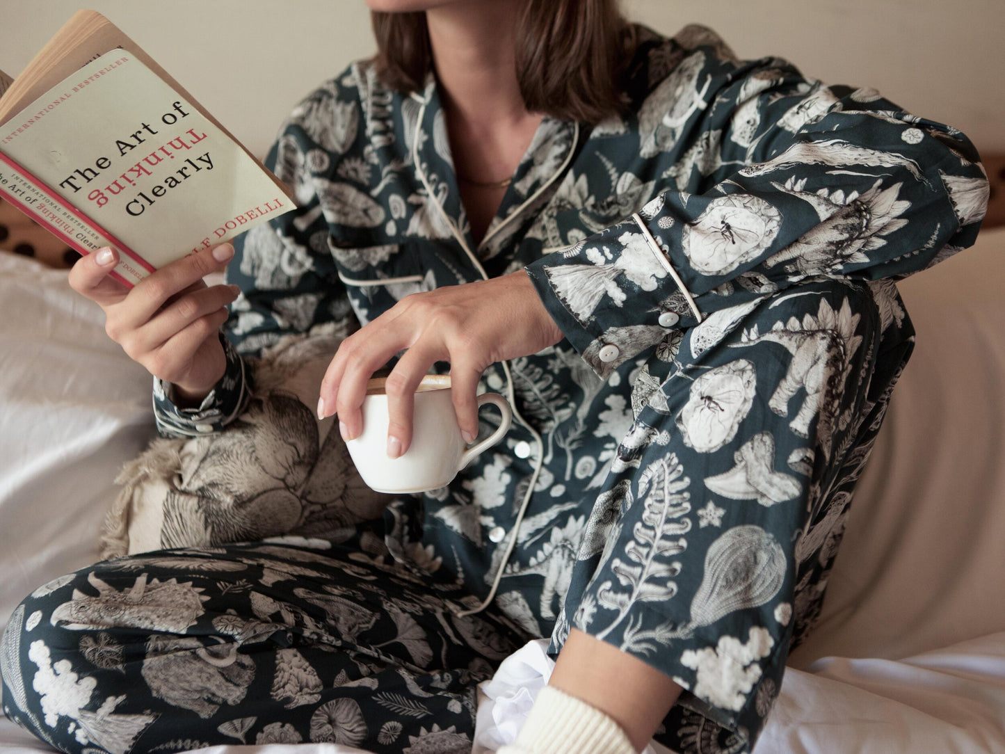This high-quality womens Pj features the beautiful prehistoric dinosaurier illustrations by tattoo artist Suflanda. It coomes with boxy shaped long-sleeve shirt and long pants with Elasticated waist with drawstring.