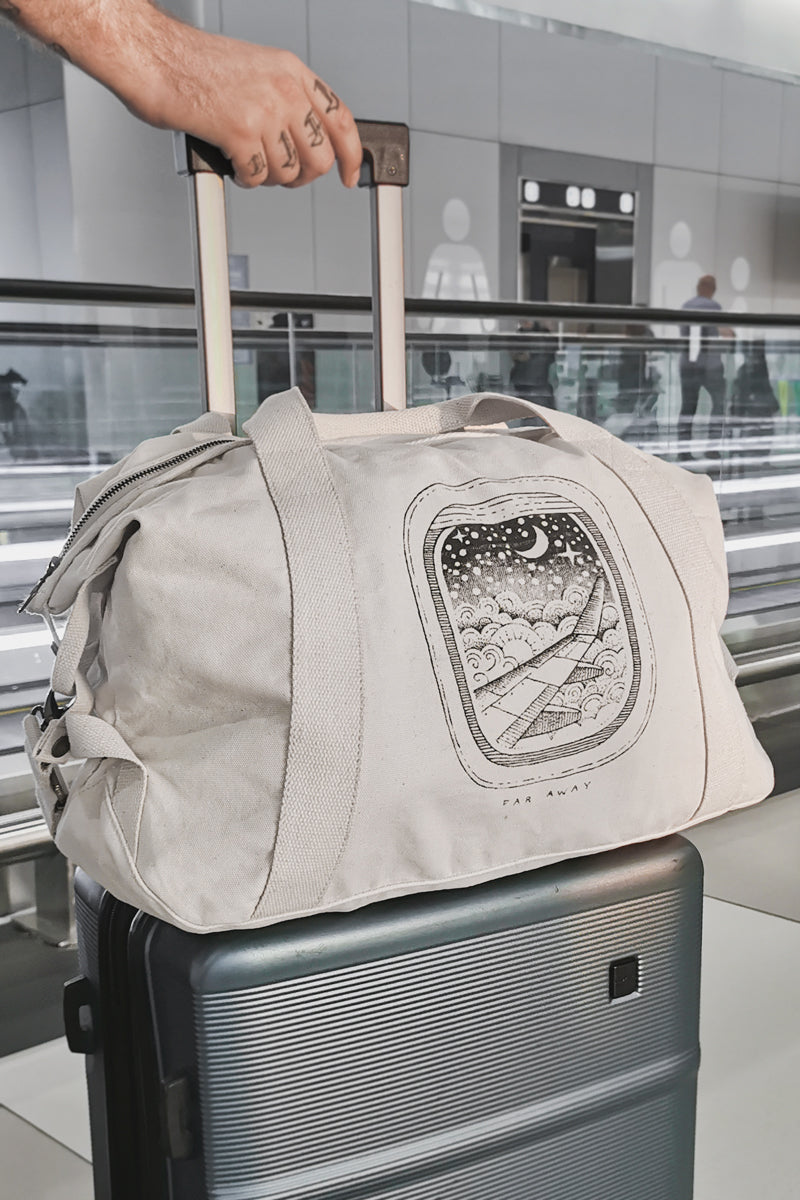 Off-White Duffle Bag With Plane and Moon Illustration on an Airport