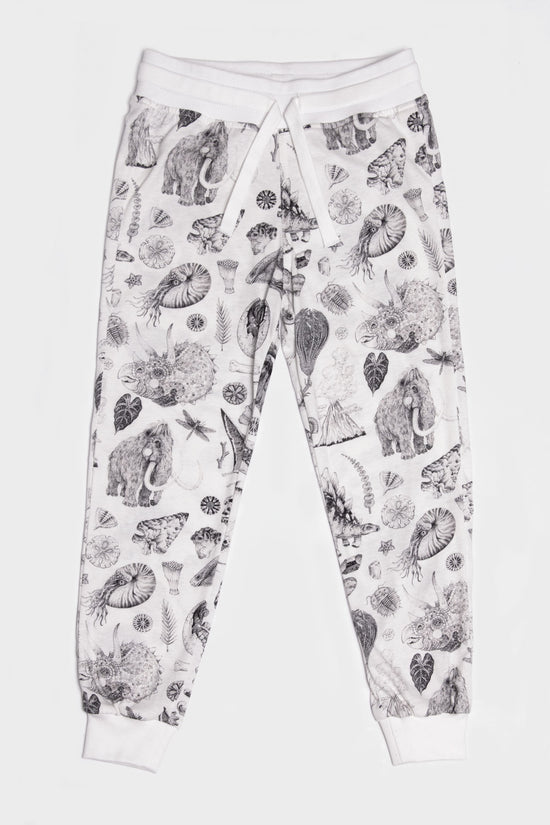 Load image into Gallery viewer, The lightweight jersey track pants made out of 100% cotton offer big comfort without compromising on cool. With our famous prehistoric print by Tattoo-Artist Suflanda the elasticated waist and the adjustable string detail will make sure you’re the coolest kid in town.
