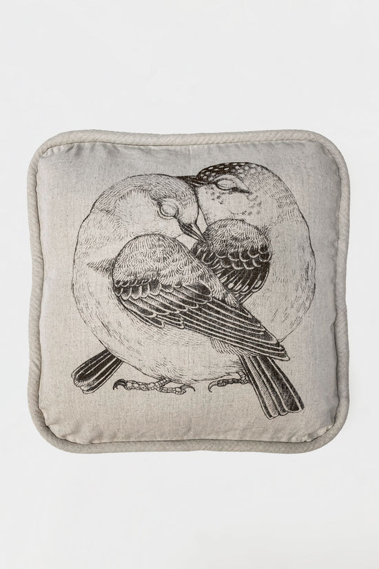 Load image into Gallery viewer, A soft cushion made by hand in Bali.This squared cushion with its round edges features the illustration of two beautiful love birds by Tattoo-Artist Suflanda. Whilst all of our cushions are great on their own, they match perfectly with our other cushion as well - a top team to spread all the love! Perfect as a gift!
